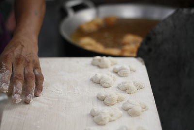 Cropped image of hand preparing food at street market