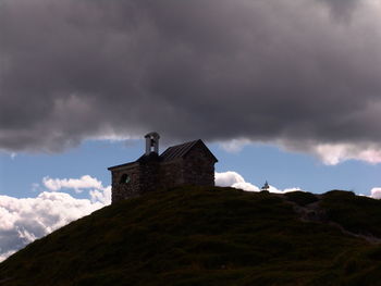 Low angle view of building against cloudy sky