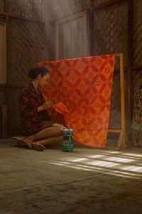 Young woman sitting on floor