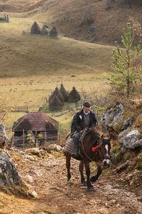 The man and his horse early in the morning, going to the next village to sell cheese and milk. 