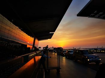 Panoramic view of city street against sky during sunset
