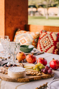 Table served with tableware and assorted ripe fruits and delicious appetizers on terrace