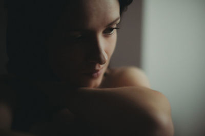 Close-up portrait of young woman looking away