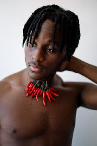 Black man wearing chili necklace portrait