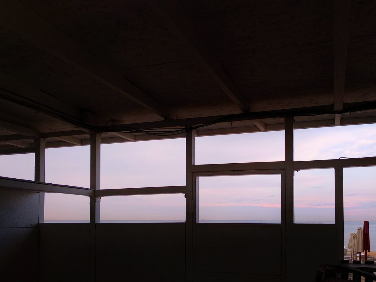 window, indoors, sky, no people, architecture, built structure, glass - material, nature, transparent, day, silhouette, low angle view, sunset, building, cloud - sky, roof, ceiling, window frame