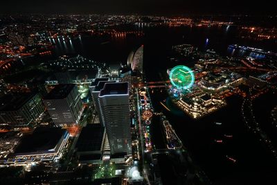 High angle view of city lit up at night