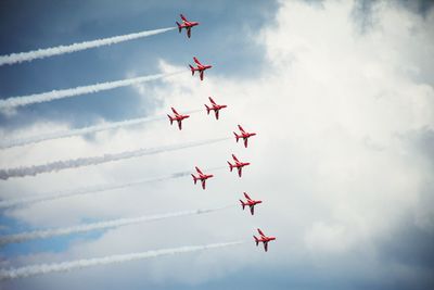 Low angle view of airshow against sky