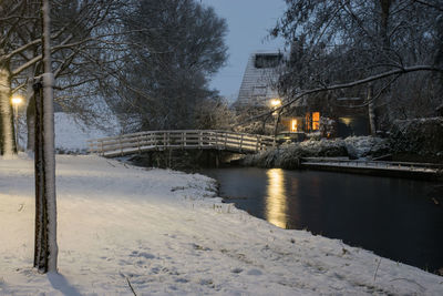 Bridge over river during winter