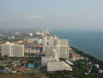 High angle view of buildings by sea against sky