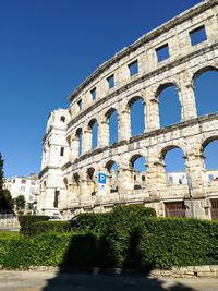 Low angle view of historical building against blue sky