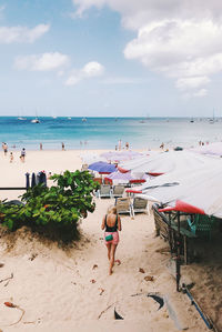 People on beach against sky