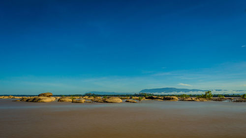 Scenic view of sea against blue sky