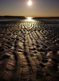 Scenic view of beach against sky during sunset