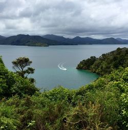 Scenic view of lake against cloudy sky