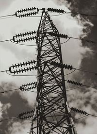 Low angle view of electricity pylon against sky