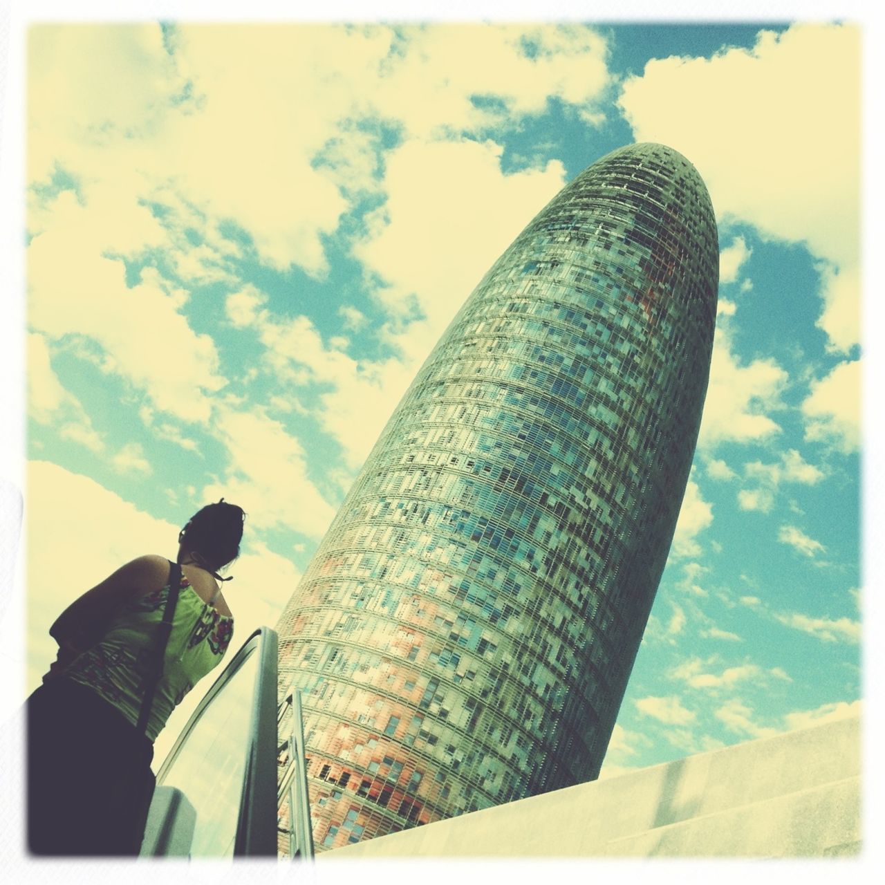 low angle view, transfer print, sky, architecture, built structure, building exterior, auto post production filter, cloud - sky, tall - high, tower, cloud, outdoors, cloudy, day, no people, city, tall, modern, sunlight, building