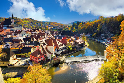 Scenic view of river amidst buildings against sky