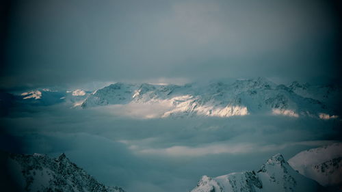 Scenic view of snow covered mountains against sky