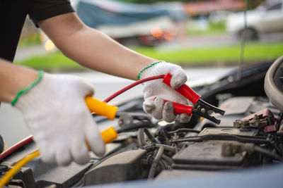 Cropped image of man repairing car