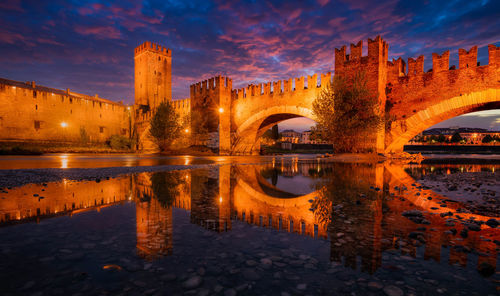 Castelvecchio bridge over the adige river in verona, italy at twilight.