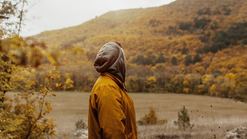 Rear view of man standing on mountain