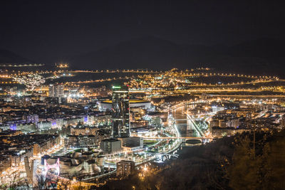 High angle view of illuminated cityscape against sky at night