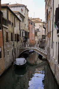 Colorful traditional venetian houses in a canal with moored boats in cannaregio - venice