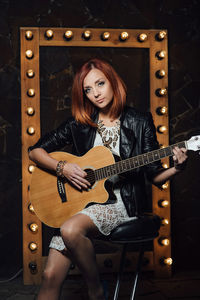 Portrait of a young woman with guitar