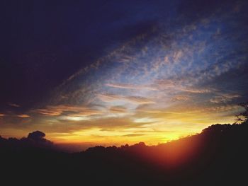 Silhouette landscape against sunset sky