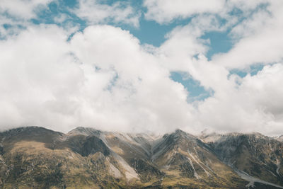 Scenic view of mountains against cloudy sky