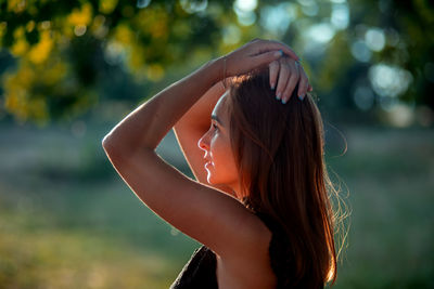 Side view of young woman standing outdoors