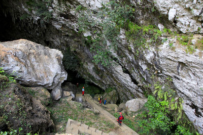 High angle view of people on rock by mountain