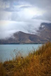 Scenic view of lake and mountains against sky