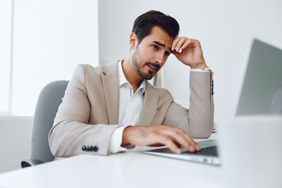 Businesswoman using laptop at home