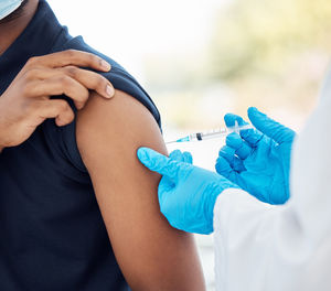 Midsection of doctor examining patient in hospital