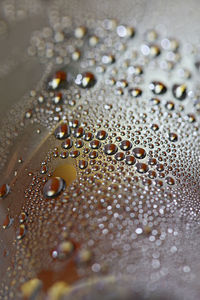 Full frame shot of raindrops on wet glass