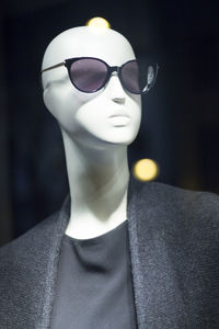 Close-up of sunglasses and clothes on mannequin in store