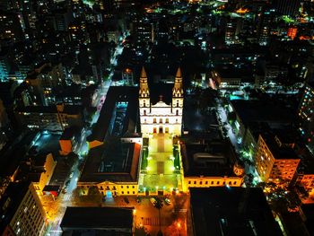 High angle view of city lit up at night