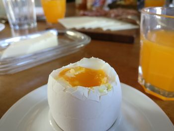 Close-up of tasty breakfast egg and healthy orange juice on table