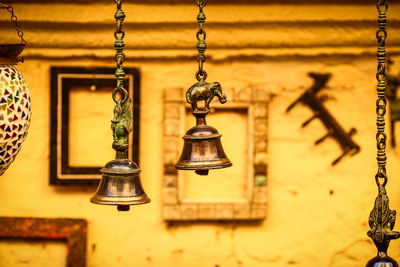 Close-up of bells hanging hanging outdoors