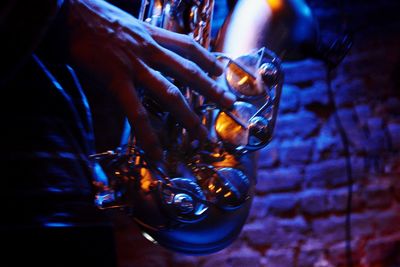 Close-up of hand holding lit candle