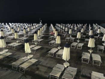 High angle view of empty chairs against sky at night