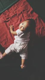 Portrait of cute baby girl crawling on bed