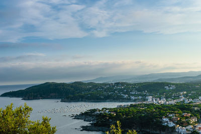 Scenic view of sea by city against sky