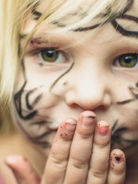 Close-up portrait of girl with face paint