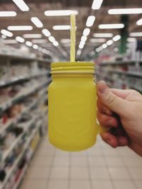 Close-up of person holding yellow juice