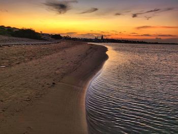 Scenic view of beach against sky during sunset