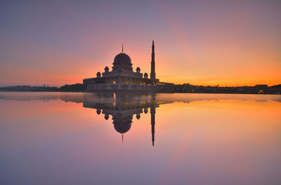 Reflection of temple in river during sunset