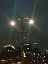 Low angle view of illuminated street light at night