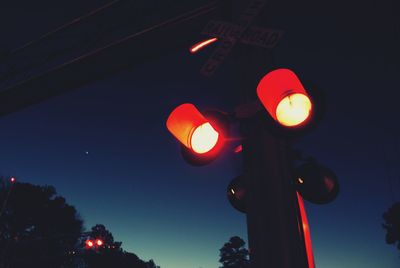 Low angle view of illuminated street light at night